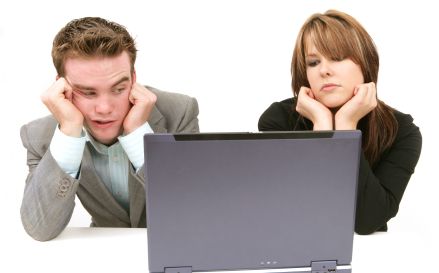 Couple bored of waiting for computer
