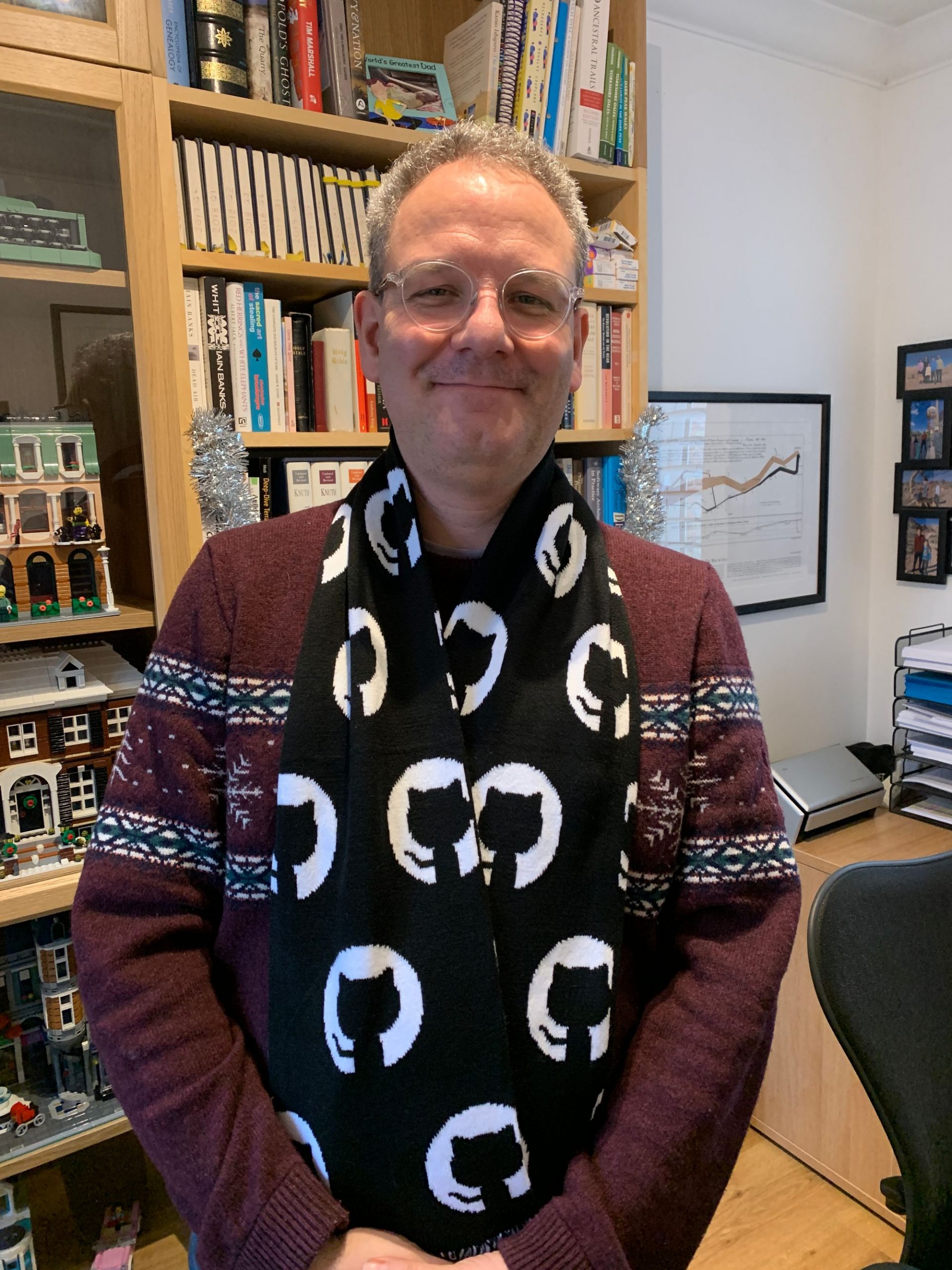 A handsome forty-something software engineer models his new GitHub-branded scarf